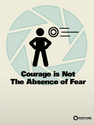 A High Energy Pellet about to hit a Test Subject on an Aperture Science propaganda poster, titled "Courage is Not the Absence of Fear"